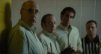 Movie still from “Win Win” (2011), directed by Tom McCarthy – A group of men standing next to each other in front of a wall; Medium shot, Over the shoulder angle