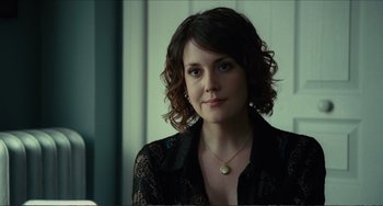 Movie still from “Win Win” (2011), directed by Tom McCarthy – A beautiful woman with short curly brown hair wearing a black shirt; Close Up shot, Over the shoulder angle