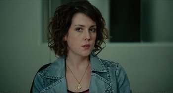 Movie still from “Win Win” (2011), directed by Tom McCarthy – A person with curly hair wearing a necklace; Close Up shot, Over the shoulder angle