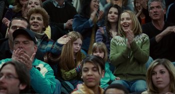 Movie still from “Win Win” (2011), directed by Tom McCarthy – A group of people sitting in a room clapping; Medium shot, Over the shoulder angle