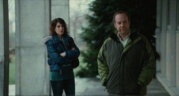 Movie still from “Win Win” (2011), directed by Tom McCarthy – A man and a woman standing next to each other on a sidewalk; Medium shot, Over the shoulder angle