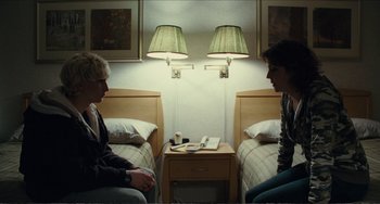 Movie still from “Win Win” (2011), directed by Tom McCarthy – Two people sitting on a bed in a hotel room; Medium shot, Over the shoulder angle