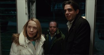 Movie still from “Win Win” (2011), directed by Tom McCarthy – Two men and a woman standing next to each other in front of a building; Medium shot, Over the shoulder angle