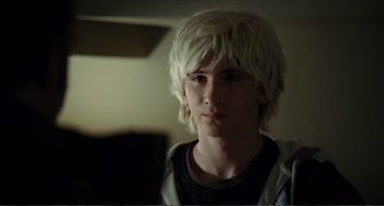 Movie still from “Win Win” (2011), directed by Tom McCarthy – A young man with white hair is looking at the camera; Close Up shot, Over the shoulder angle