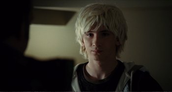 Movie still from “Win Win” (2011), directed by Tom McCarthy – A young man with blonde hair is looking at the camera; Close Up shot, Over the shoulder angle