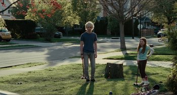 Movie still from “Win Win” (2011), directed by Tom McCarthy – A man standing in the middle of a yard with a stick; Wide shot, Over the shoulder angle