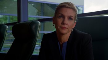 Movie still from “Better Call Saul” (2015), created by Vince Gilligan – A person sitting in a chair wearing a suit; Close Up shot, Over the shoulder angle