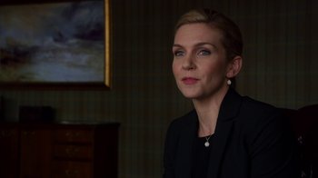 Movie still from “Better Call Saul” (2015), created by Vince Gilligan – A woman in a black suit is sitting in a room; Close Up shot, Over the shoulder angle