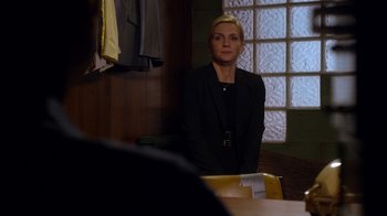 Movie still from “Better Call Saul” (2015), created by Vince Gilligan – A woman standing in front of a table; Medium shot, Over the shoulder angle