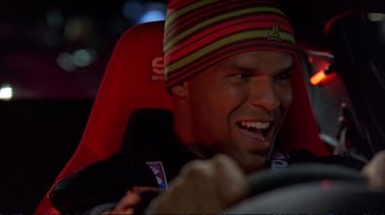 Movie still from “2 Fast 2 Furious” (2003), directed by John Singleton – A person in a car wearing a hat; Close Up shot, Low angle