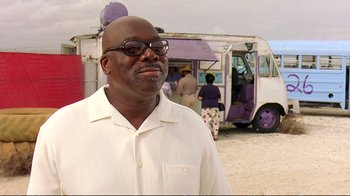 Movie still from “2 Fast 2 Furious” (2003), directed by John Singleton – A man standing in front of a food truck; Close Up shot, Low angle