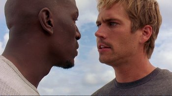 Movie still from “2 Fast 2 Furious” (2003), directed by John Singleton – Two men face each other in a face - to - face contest; Close Up shot, Over the shoulder angle