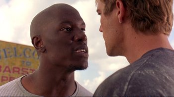Movie still from “2 Fast 2 Furious” (2003), directed by John Singleton – Two young men face each other in a conversation; Close Up shot, Over the shoulder angle