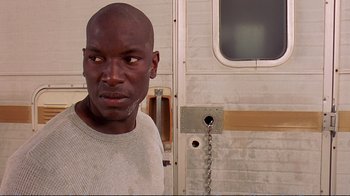 Movie still from “2 Fast 2 Furious” (2003), directed by John Singleton – A man standing in front of a trailer; Close Up shot, Low angle