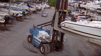 Movie still from “2 Fast 2 Furious” (2003), directed by John Singleton – A forklift that is parked next to a boat; Extreme Wide shot, Low angle