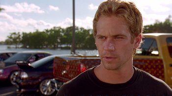 Movie still from “2 Fast 2 Furious” (2003), directed by John Singleton – A man with blonde hair is looking at the camera; Close Up shot, Over the shoulder angle