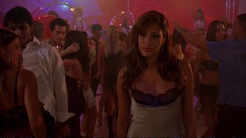 Movie still from “2 Fast 2 Furious” (2003), directed by John Singleton – A woman in a white dress in a crowd; Medium shot, Over the shoulder angle