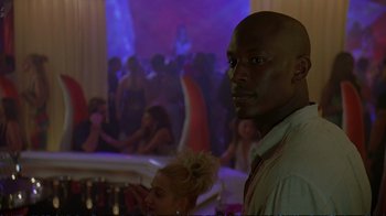 Movie still from “2 Fast 2 Furious” (2003), directed by John Singleton – A man and a woman in front of a crowd; Close Up shot, Over the shoulder angle