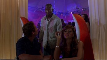 Movie still from “2 Fast 2 Furious” (2003), directed by John Singleton – A group of people sitting at a table; Medium shot, Over the shoulder angle