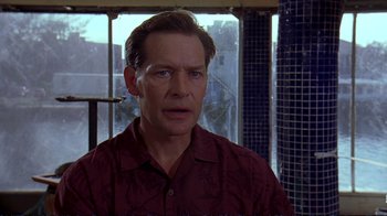 Movie still from “2 Fast 2 Furious” (2003), directed by John Singleton – A person wearing a red shirt near a window; Close Up shot, Low angle