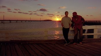 Movie still from “2 Fast 2 Furious” (2003), directed by John Singleton – Two men standing on a pier at sunset; Wide shot, Low angle