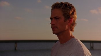 Movie still from “2 Fast 2 Furious” (2003), directed by John Singleton – A person near a body of water; Close Up shot, Over the shoulder angle