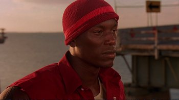 Movie still from “2 Fast 2 Furious” (2003), directed by John Singleton – A person wearing a hat; Close Up shot, Low angle