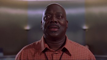 Movie still from “2 Fast 2 Furious” (2003), directed by John Singleton – A person wearing a red and white shirt; Close Up shot, Low angle