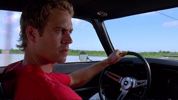 Movie still from “2 Fast 2 Furious” (2003), directed by John Singleton – A man sitting in the driver's seat of a car; Close Up shot, Over the shoulder angle