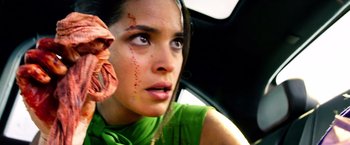 Movie still from “6 Underground” (2019), directed by Michael Bay – A woman with a green shirt is looking out the window; Close Up shot, Low angle