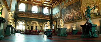 Movie still from “6 Underground” (2019), directed by Michael Bay – A large room filled with furniture and paintings; Extreme Wide shot, Low angle