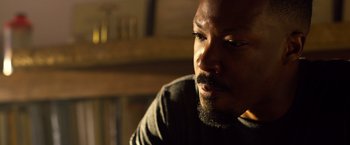 Movie still from “6 Underground” (2019), directed by Michael Bay – A person with a beard; Close Up shot, Over the shoulder angle