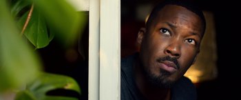Movie still from “6 Underground” (2019), directed by Michael Bay – A man's face as he looks out a window; Close Up shot, Low angle