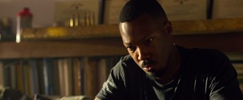 Movie still from “6 Underground” (2019), directed by Michael Bay – A person sitting in front of a window; Close Up shot, Over the shoulder angle