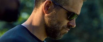 Movie still from “6 Underground” (2019), directed by Michael Bay – A person wearing sunglasses; Close Up shot, Low angle