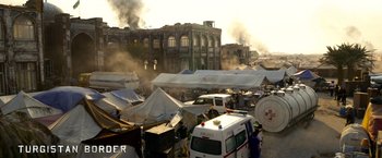 Movie still from “6 Underground” (2019), directed by Michael Bay – An open air market with tents , tents , and tents; Extreme Wide shot, High angle