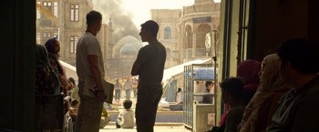 Movie still from “6 Underground” (2019), directed by Michael Bay – A group of men standing next to each other on a street; Wide shot, Over the shoulder angle