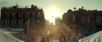 Movie still from “6 Underground” (2019), directed by Michael Bay – A group of people walking on a city street at sunset; Extreme Wide shot, High angle