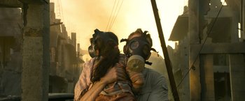 Movie still from “6 Underground” (2019), directed by Michael Bay – A man and a woman wearing gas masks; Close Up shot, Over the shoulder angle