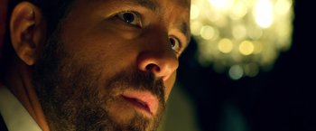 Movie still from “6 Underground” (2019), directed by Michael Bay – A man with a beard looking up; Extreme Close Up shot, Low angle