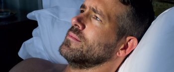 Movie still from “6 Underground” (2019), directed by Michael Bay – A person with a beard; Close Up shot, Overhead angle