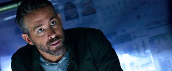 Movie still from “6 Underground” (2019), directed by Michael Bay – A person wearing a jacket; Close Up shot, Over the shoulder angle