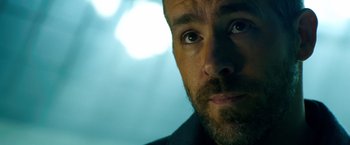 Movie still from “6 Underground” (2019), directed by Michael Bay – A man's eyes and face; Close Up shot, Over the shoulder angle