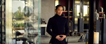 Movie still from “6 Underground” (2019), directed by Michael Bay – A man in a black shirt is posing for a picture; Medium shot, Over the shoulder angle