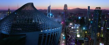 Movie still from “6 Underground” (2019), directed by Michael Bay – An aerial view of a city at night with lights; Extreme Wide shot, High angle