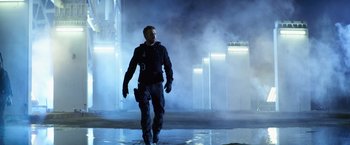 Movie still from “6 Underground” (2019), directed by Michael Bay – A man walking in the rain holding a gun; Wide shot, Low angle