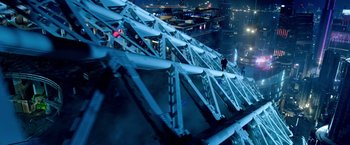 Movie still from “6 Underground” (2019), directed by Michael Bay – A man standing on top of a metal structure at night; Extreme Wide shot, Overhead angle