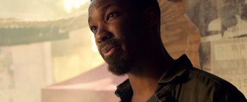 Movie still from “6 Underground” (2019), directed by Michael Bay – A person with a beard; Close Up shot, Low angle