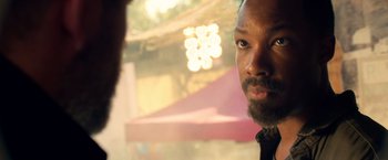 Movie still from “6 Underground” (2019), directed by Michael Bay – A person with a beard looking into the distance; Close Up shot, Over the shoulder angle