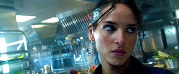 Movie still from “6 Underground” (2019), directed by Michael Bay – A person with a hair brush on their head; Close Up shot, Low angle